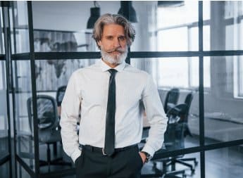 confident mature businessman with grey hair and be.jpg