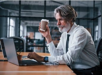 mature businessman with grey hair and beard in for.jpg